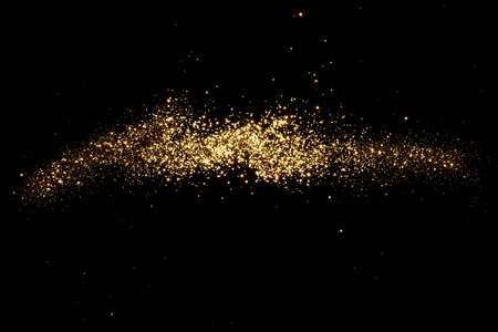 Golden blurred bokeh lights on black background. Glitter sparkle stars for celebrate. Overlay for...
