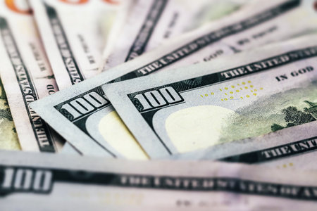 American paper dollar bills background. Hundred dollar banknotes texture, currency concept with tilt-shift effectの写真素材