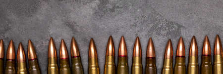 Bullets on gray background banner with copy space. Cartridges 7.62 caliber for assault rifle....