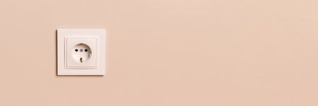 White european electrical outlet on modern beige wall with copy space banner. Wide panoramic headerの写真素材