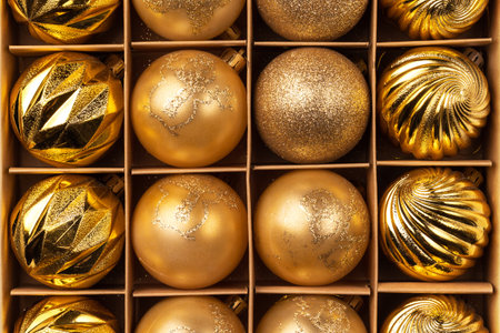 Golden glitter Christmas tree balls in cardboard craft box. Top viewの写真素材