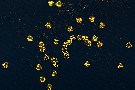 Dark blue background with golden glitter and hearts confetti