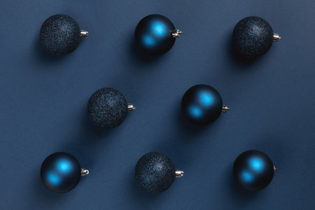 Christmas card with blue matte and glitter balls on dark blue backgroundの写真素材