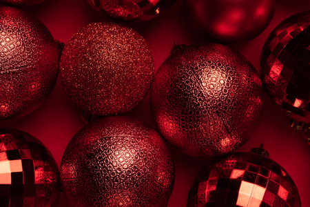 Christmas card with red glitter bauble balls on red backgroundの写真素材