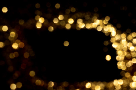 Golden blurred bokeh lights on black background. Glitter sparkle stars for celebrate. Overlay for your designの写真素材