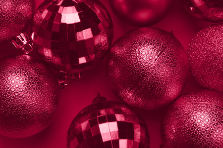 Christmas card with viva magenta glitter bauble balls on carmine red backgroundの写真素材