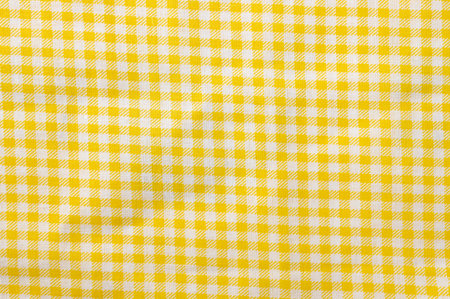 Yellow and white checkered cotton texture. Fabric textile backgroundの写真素材