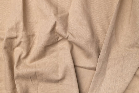 Natural linen fabric texture. Flaxen textile background, top view. Rough crumpled burlapの写真素材