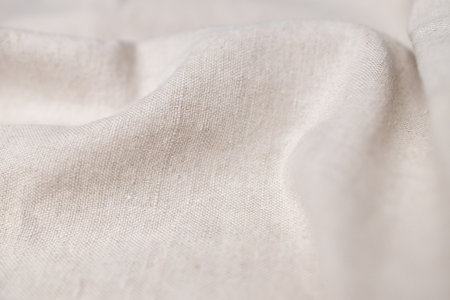 Natural linen fabric texture. Rough crumpled burlap background. Selective focusの写真素材