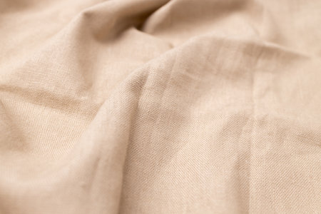 Natural linen fabric texture. Rough crumpled burlap background. Selective focusの写真素材