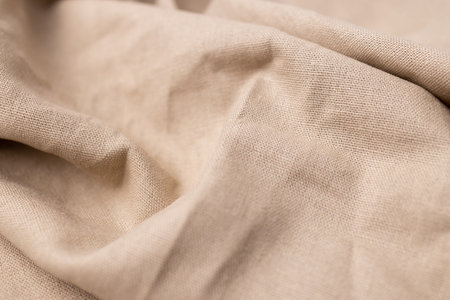 Natural linen fabric texture. Rough crumpled burlap background. Selective focusの写真素材
