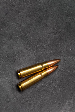 Bullets for assault rifle on gray concrete background, top view. Cartridge 7.62 caliber for ak 47 closeupの写真素材