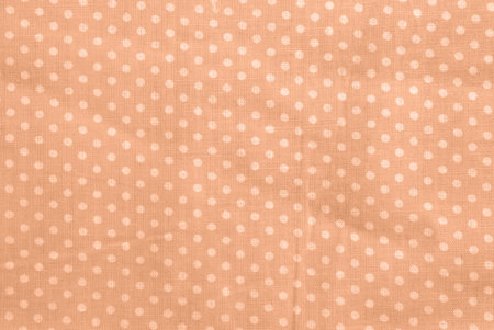 Peach fuzz polka dot cotton texture. Fabric textile backgroundの写真素材