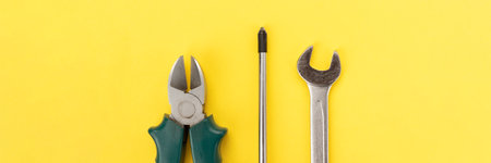 Work tools on bright yellow background banner. Panoramic web header. Wide screen wallpaper.