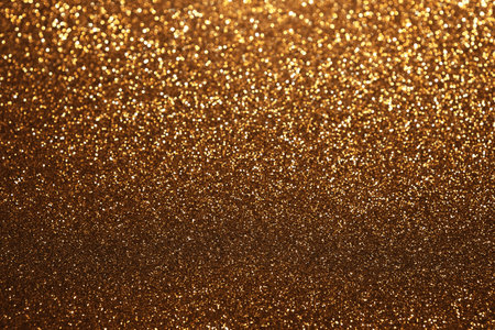 Golden glitter festive bokeh background, abstract defocused texture. Holiday lights.の写真素材