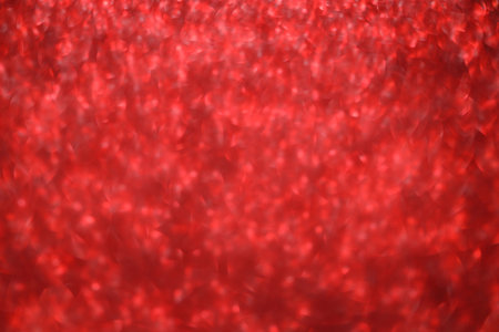 Red glitter bokeh background with sparkling light, abstract defocused texture. Holiday lights.の写真素材