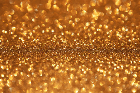 Golden glitter festive bokeh background, abstract defocused texture. Holiday lightsの写真素材
