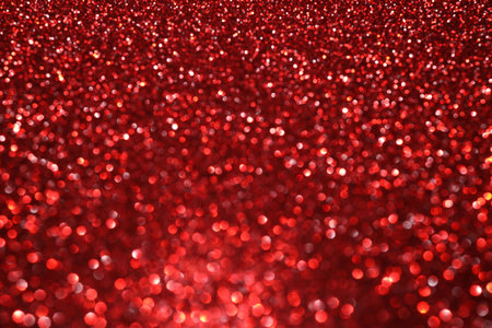 Red glitter bokeh background with sparkling light, abstract defocused texture. Holiday lights.の写真素材
