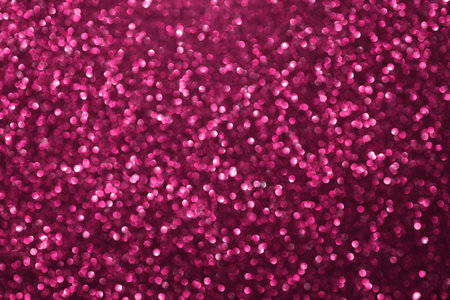 Pink glitter bokeh background with defocused sparkling lights, abstract shiny texture. Holiday lights.の写真素材