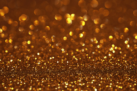 Golden glitter festive bokeh background, abstract defocused texture. Holiday lightsの写真素材