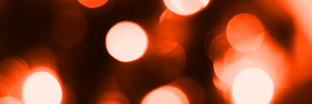Blurred lights, dark orange background, banner texture. Abstract bokeh with soft light header. Wide screen wallpaper. Panoramic web banner with copy space for designの写真素材