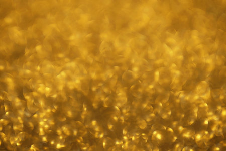 Golden glitter festive bokeh background, abstract defocused texture. Holiday lightsの写真素材