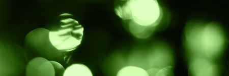 Blurred lights, green background banner. Abstract bokeh with soft light header. Wide screen wallpaper. Panoramic web banner with copy space for designの写真素材