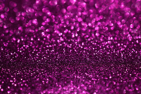 Pink magenta glitter bokeh background with defocused sparkling lights, abstract shiny texture. Holiday lights.の写真素材