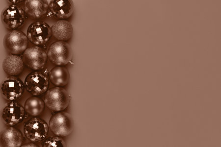 Christmas card with brown, mocha mousse glitter bauble balls on brown background with copy space. Demonstrating color, trend 2025 yearの写真素材