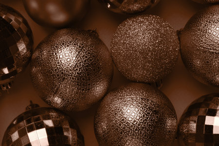 Christmas card with brown, mocha mousse glitter bauble balls on brown background. Demonstrating color, trend 2025 yearの写真素材