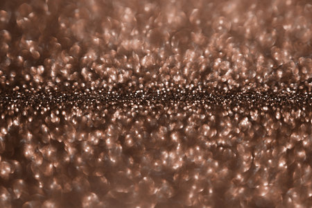 Mocha Mousse, brown sparkling glitter bokeh background, abstract defocused texture. Holiday lights.の写真素材