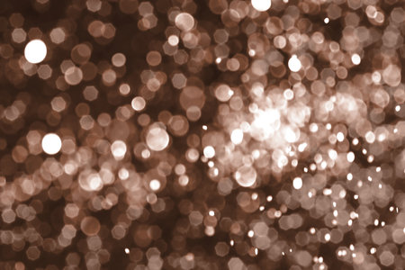 Brown, mocha mousse sparkling glitter bokeh background, abstract defocused texture. Holiday lights. Demonstrating color, trend 2025 year.の写真素材