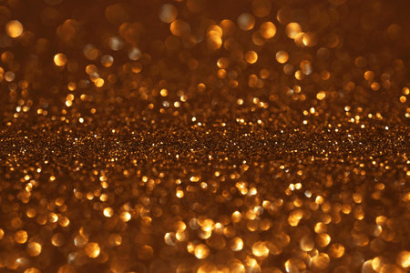 Golden glitter festive bokeh background, abstract defocused texture. Holiday lightsの写真素材