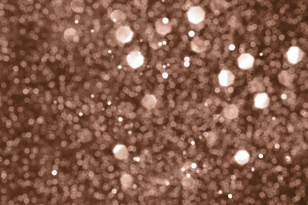 Brown, mocha mousse sparkling glitter bokeh background, abstract defocused texture. Holiday lights. Demonstrating color, trend 2025 year.の写真素材