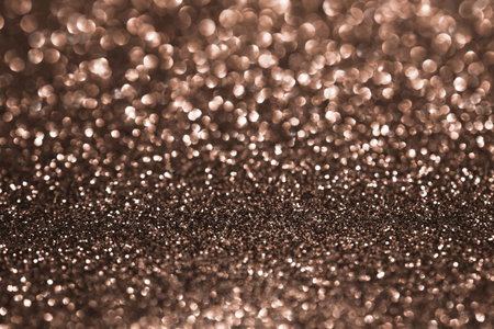 Mocha Mousse, brown sparkling glitter bokeh background, abstract defocused texture. Holiday lights. Demonstrating color, trend 2025 year.の写真素材