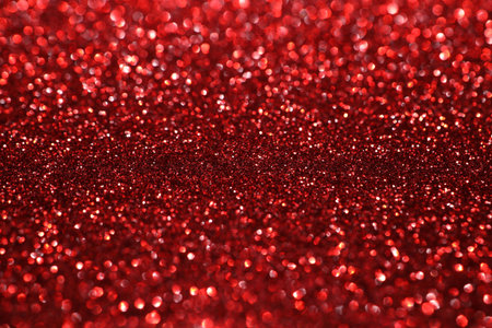 Red glitter bokeh background with sparkling light, abstract defocused texture. Holiday lights.の写真素材