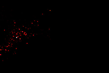 Red blurred bokeh lights on black background. Glitter sparkle confetti for celebrate. Overlay for your design.の写真素材