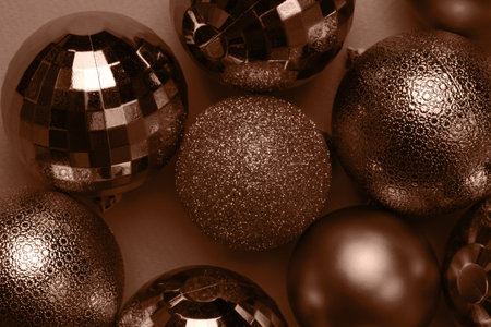 Christmas card with brown, mocha mousse glitter bauble balls on brown background. Demonstrating color, trend 2025 yearの写真素材