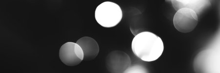 Blurred lights black and white background, banner texture. Abstract bokeh with soft light header. Wide screen wallpaper. Panoramic web banner with copy space for design.の写真素材