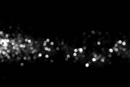 White gray blurred bokeh lights on black background. Glitter sparkle stars for celebrate. Overlay for your design.の写真素材