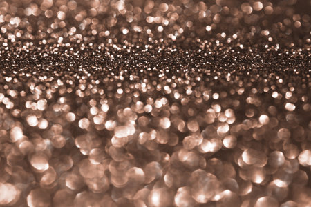 Mocha Mousse, brown sparkling glitter bokeh background, abstract defocused texture. Holiday lights. Demonstrating color, trend 2025 year.の写真素材