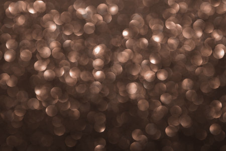 Mocha Mousse, brown sparkling glitter bokeh background, abstract defocused texture. Holiday lights. Demonstrating color, trend 2025 year.の写真素材