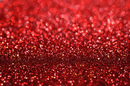 Red glitter bokeh background with sparkling light, abstract defocused texture. Holiday lights.の写真素材