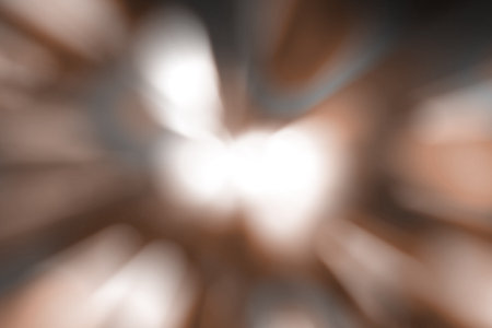 Blurred lights dark brown, mocha mousse background. Abstract soft explosion effect. Centric motion pattern. Demonstrating color, trend 2025 year.の写真素材