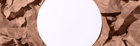 White empty blank circle mockup banner on multiple pieces of torn brown, mocha mousse crumpled, wrinkled recycle craft paper background. Composition with copy space and place for textの写真素材