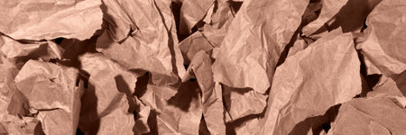 Multiple pieces of torn brown, mocha mousse crumpled, wrinkled recycle craft paper background texture, top view banner.の写真素材