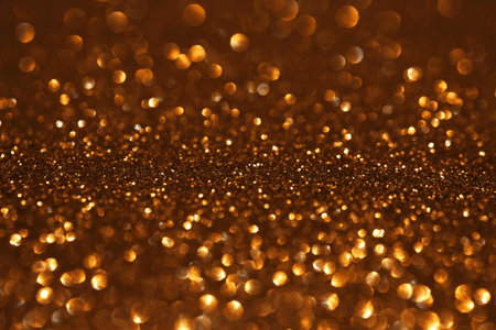 Golden glitter festive bokeh background, abstract defocused texture. Holiday lightsの写真素材