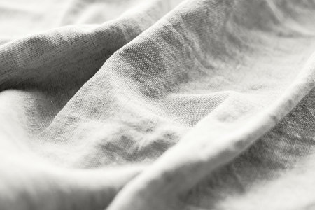Natural cloud white linen fabric texture. Rough crumpled burlap background. Demonstrating color, trend.の写真素材