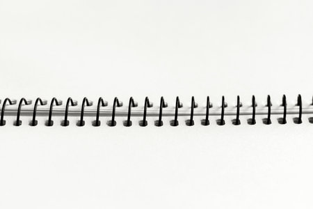 Open spiral notebook with blank empty cloud white sheets, closeup top view, paper background.の写真素材