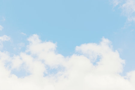 Beautiful blue sky with light white cloud background, overcast. Demonstrating color.